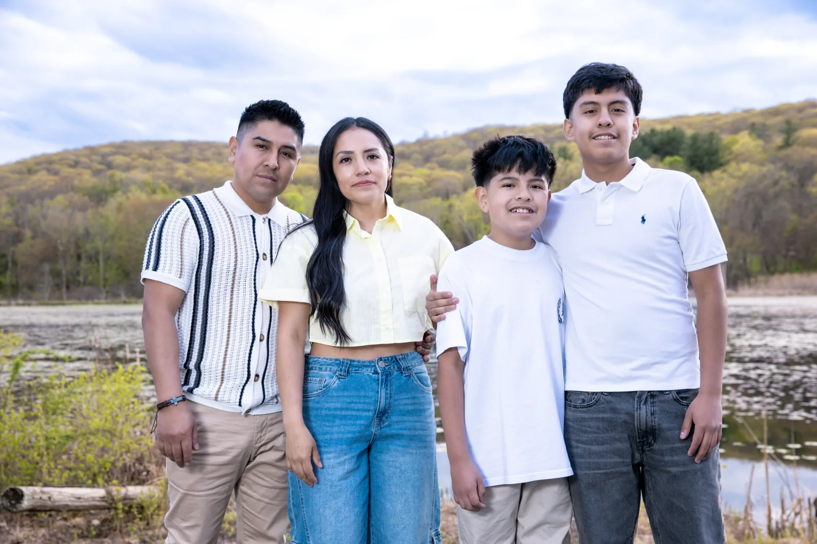 The Sacasari family, owners of NJ Auto Tech Automotive Specialist, outdoors near a Hudson Valley lake